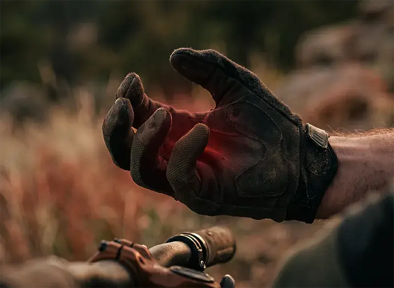 A mountain bikers hand with fingers locked in a death-grip from gripping the handlebar too hard for too long illustrating hand pain from grip strength loss